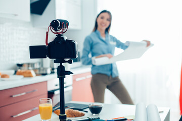 Fototapeta na wymiar Camera with microphone on tripod in the kitchen
