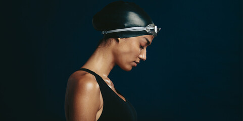 Professional female swimmer with goggles and a hat