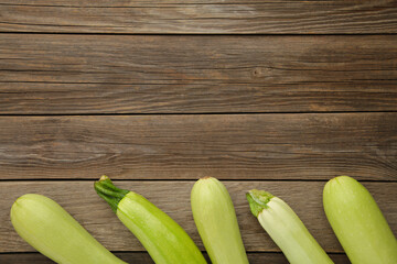 Fresh organic zucchini on the grey wooden table. Fresh squash