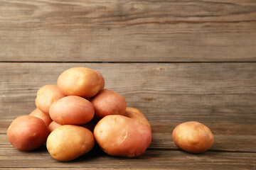 Potatoes on grey wooden background, top view