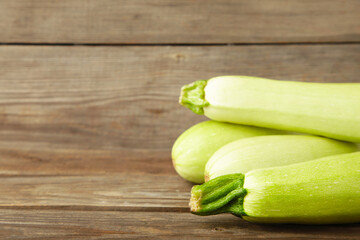Fresh organic zucchini on the grey wooden table. Fresh squash