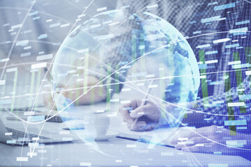 Multi exposure of businessman working on laptop on background. International business hologram in front. Concept of success.