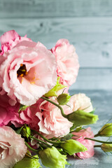 Beautiful pink, purple and white eustoma flower lisianthus in full bloom with green leaves. Bouquet of flowers on pink.