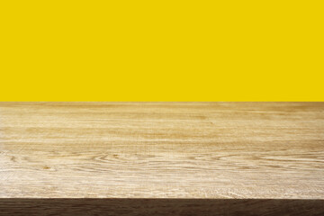 Wood table on yellow background.