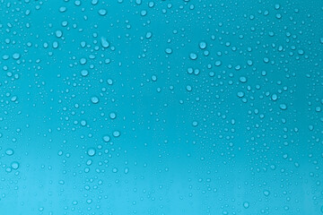 Fototapeta na wymiar Water drops on blue background.