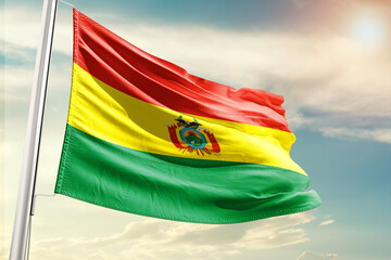 bolivia national flag cloth fabric waving on the sky with beautiful sun light - Image