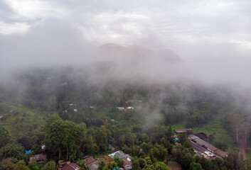 Aerial Drone Shot Flying by Cloudy Misty Foggy Lushoto village in Usambara Mountains. Remote Place in Tanga Province, Tanzania, Africa