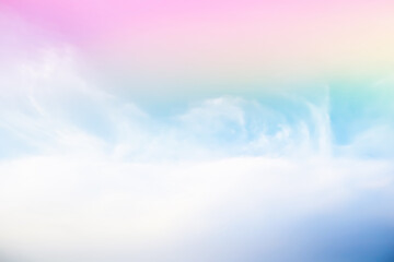 Dramatic panorama view of blurry beautiful soft white clouds and rainbow color gradient effect on blue sky background.