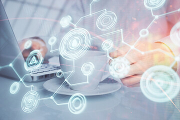 Social network theme hologram with businessman working on computer on background. Multi exposure.