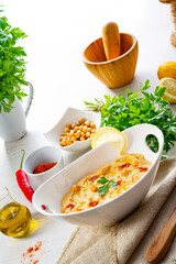 hummus paste with lemon and chilli on white background