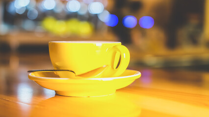 A cup of coffee decorated with a flower drawing with milk in a coffee shop