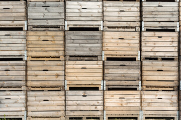 Wooden fruit boxes stacked on top of each other. Fruit containers prepared before harvest.