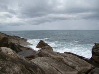 Ocean waves and big rocks, overcast