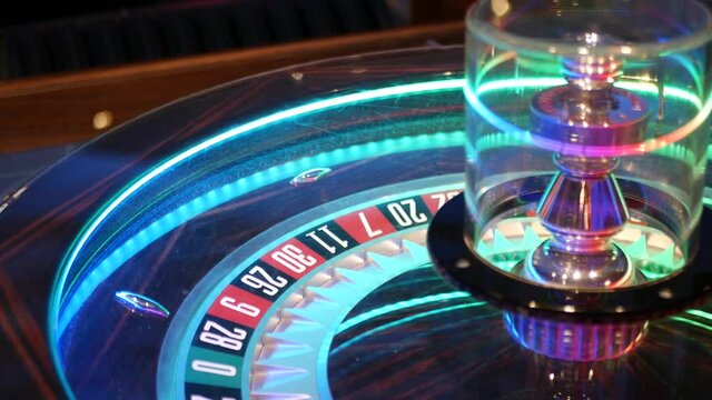 French style roulette table for money playing in Las Vegas, USA. Spinning wheel with black and red sectors for risk game of chance. Hazard amusement with random algorithm, gambling and betting symbol.