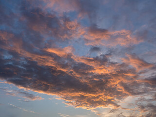 Evening sky with blue, white and orange clouds