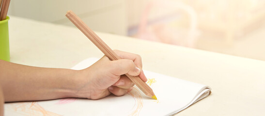 Young child write at notebook. Pencil draw stars. Close up. Education painting. kindergarten draw exercise. Preschool picture. Horizontal