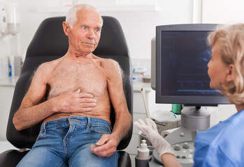 Professional sonographer explaining future the ultrasound diagnostic procedure to patient