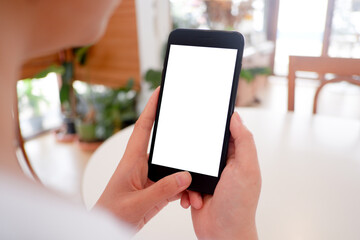 Cropped shot view of woman’s Hands hold the smartphone with blank copy space screen for your information content or text message on the gray granite at the modern place.