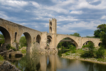 Medieval stone bridge over a river in Besalu, Catalonia famous touristic landmark