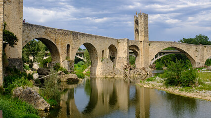 Fototapeta na wymiar Medieval stone bridge over a river in Besalu, Catalonia famous touristic landmark