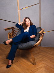 business woman sitting in a chair in a chic office