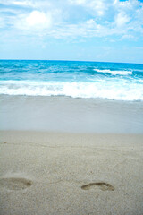 Soft wave of turquoise sea water on the sandy beach