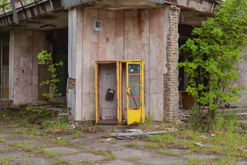 Fototapeta na wymiar broken phone booth in abandoned Pripyat