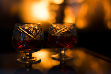 Glass of wine in front of a hot fireplace.