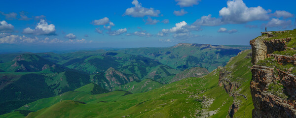 Fototapeta na wymiar Man Stands on the Abyss Bermamyt Plateau, Caucasus Elbrus Region, Panorama