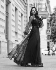 Elegant woman wearing long blue evening dress. Pretty lady posing outdoors. Fashionable stylish...