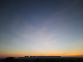 Fototapeta na wymiar Beautiful sunset in middle of mountains