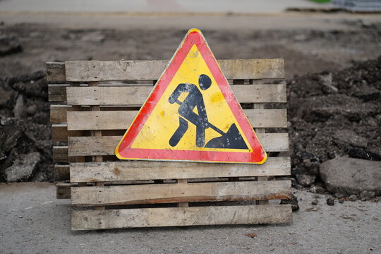 Sign of road work to inform traffic participants about carrying out repairs on road. Concept of careful and attentive driving.