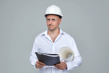 adult male in a White construction helmet. keeps the project in hand.