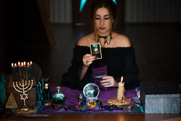   Woman fortune teller on a Tarot cards, Concept of predictions, magical rituals and wicca elements...