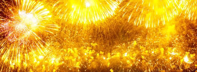 Wide festive background with yellow fireworks
