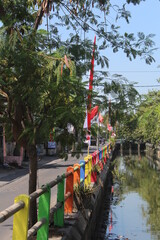 Colorful bridge fences over the river, Indonesian flag on the edge of a river