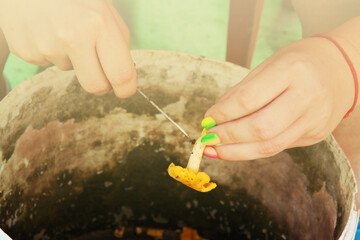 Cleaning mushrooms from the forest, womans hands. Girl clean chanterelle mushroom at home.