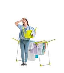 Tired woman with clean clothes and dryer on white background