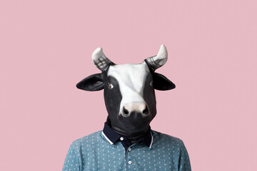 man wearing a cow mask on a pinkg background