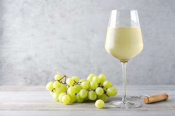 Misted glass of cold white wine on gray background