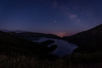 Milky Way and shooting stars in the sky above Lagoa de Fogo (Fire Lagoon) in Ribeira Grande, São Miguel Island in Azores, Portugal.