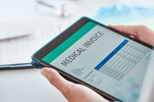 Doctor Checking A Medical Invoice In His Tablet