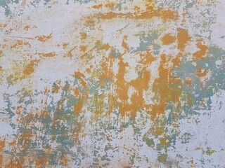 Damaged wall texture. Yellow and light green paint peeling off the wall.