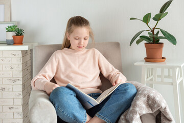 Young teenager girl reading book at home. home education concept