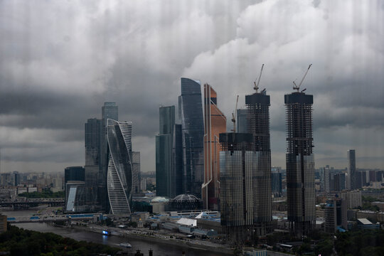 Fototapeta a view of a big city through the window where you can see that it is raining outside