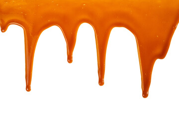 Background of flowing caramel sauce isolated on white.