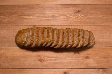 Assortment of baked bread on wooden table background