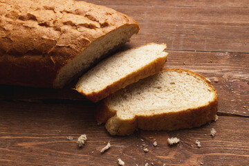 Assortment of baked bread on wooden table background