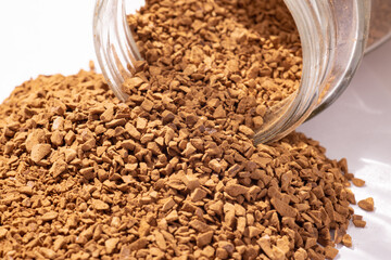 instant coffee sprinkled from the can, coffee granules, close-up, texture
