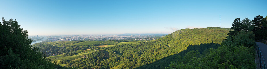 Fototapeta na wymiar Panoramic view from Leopoldsberg over the hills of Vienna Woods with Kahlenberg and the city in the morning.